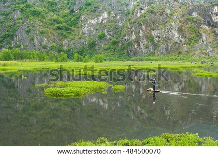Van Long, Vietnam - May 23, 2016 : Fishermen is fishing on the Van Long Reserve at Ninh Binh, Vietnam