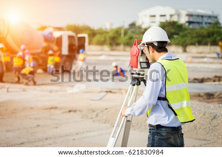 engineer surveyor working with theodolite at construction site