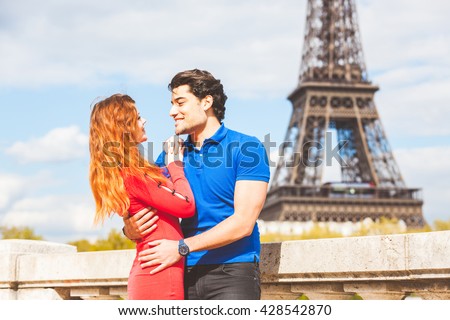 https://thumb1.shutterstock.com/display_pic_with_logo/308011/428542870/stock-photo-couple-in-love-in-paris-with-eiffel-tower-on-background-redhead-caucasian-woman-and-middle-eastern-428542870.jpg