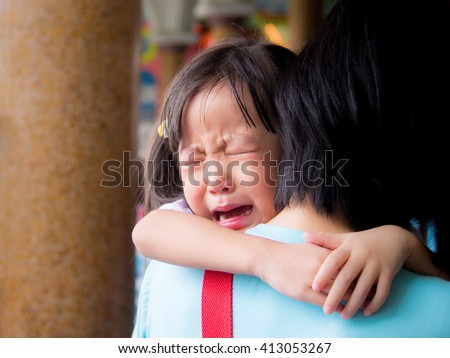 Asian baby girl hugging her mother crying
