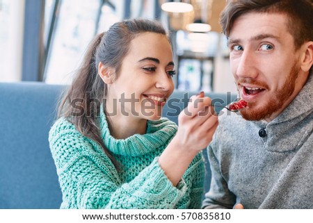 https://thumb1.shutterstock.com/display_pic_with_logo/309106/570835810/stock-photo-couple-eating-a-dessert-in-a-cafe-on-a-date-and-drinking-coffee-woman-and-man-looks-at-a-spoon-570835810.jpg