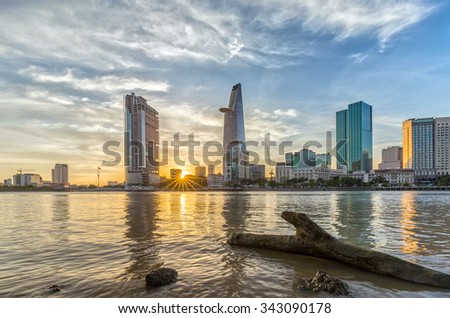 Ho Chi Minh City, Vietnam - November 20th, 2015: Sun star sunset in City with logs as the path to sun rays is lower down the skyscrapers make beautiful sunset in District 1, Ho Chi Minh City , Vietnam