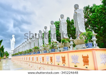 Ba Ria-Vung Tau, Vietnam - June 20th, 2014: The beauty of architecture leads to Lord Buddha big statue shining despite thunderstorms in the afternoon Dai Tong Lam Pagoda, Ba Ria Vung Tau, Vietnam