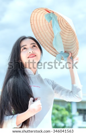 Sanctity beauty of women in Vietnam with beautiful face, big round eyes, long hair and conical hats posing pretty slim very beautiful to behold