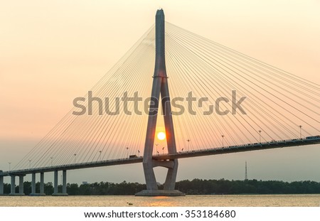 Can Tho, Vietnam - April 4th, 2015: close-up of cable stayed bridge at sunset with the sun in the abutment shown brilliant achievements of human development in the Mekong Delta in Can Tho, Vietnam