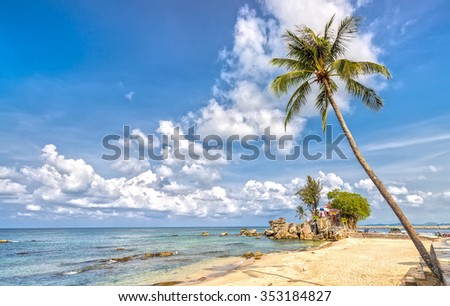 Phu Quoc, Vietnam - April 10th, 2015: Beauty temple on path volcanic rock with coconut trees overlooking island and cloudy blue sky clean beachfront attracts tourists island pearls Phu Quoc, Vietnam