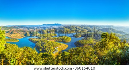 Panoramic plateau with early sunshine, vast lakes winding around mountains pine forests as giant bonsai beautiful, far away city Da lat famous tourism, it great to see sunrise proving this place