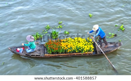 Soc Trang, Vietnam - February 3rd, 2016: The couple sold strenuous rowing on the river daisies to survive in the morning on the Mekong river in Soc Trang, Vietnam
