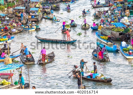Soc Trang, Vietnam - February 3rd, 2016: Customers go market on river for women with colorful rowing boats clothes shopping agricultural products in morning floating market Soc Trang, Vietnam
