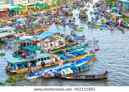 Soc Trang, Vietnam - February 3rd, 2016: Bustling produce market in morning on river with hundreds boats gathered fruit, flowers, vegetables traded on confluence river culture water Soc Trang, Vietnam