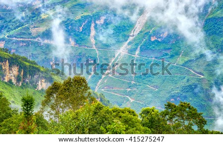 Supply dangerous winding road passes with dirt roads winding halfway up the mountain side without any corridor of protection. This beautiful stretch of road as well as in Ha Giang, Vietnam