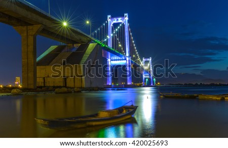 Da Nang, Vietnam - June 25th, 2015: Beauty Thuan Phuoc Bridge architecture inside marina with glowing lights rays shining down river carried reliability in Da Nang, Vietnam