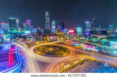 Ho Chi Minh City, Vietnam - July 23rd, 2015: Impressive beauty, colorful traffic when city lights up, trail vehicle in crowded Quach Thi Trang roundabout, Ho Chi Minh city, Vietnam