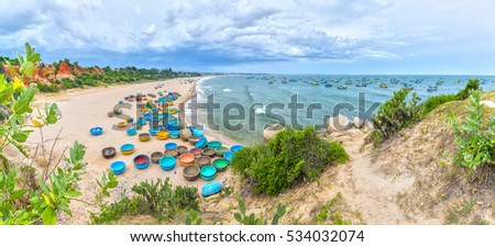 Binh Thuan, Vietnam - July 26th, 2016: Ganh Son Beach on sunny afternoon with many basket boats lined beach, this is beautiful coastline attract tourists to visit in Binh Thuan, Vietnam