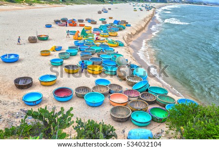 Binh Thuan, Vietnam - July 26th, 2016: Ganh Son Beach on sunny afternoon with many basket boats lined beach, this is beautiful coastline attract tourists to visit in Binh Thuan, Vietnam