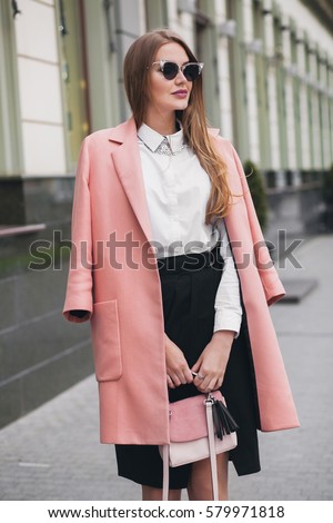 https://thumb1.shutterstock.com/display_pic_with_logo/3122657/579971818/stock-photo-young-beautiful-stylish-woman-walking-in-pink-coat-holding-purse-in-hands-smiling-happy-street-579971818.jpg