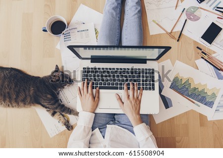 Working home concept - girl with smart phone, laptop and business reports.