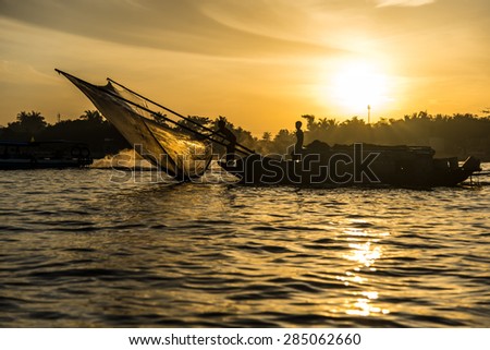 Fishing boat with fishnet on the Mekong River at sunrise. Can Tho, Vietnam.