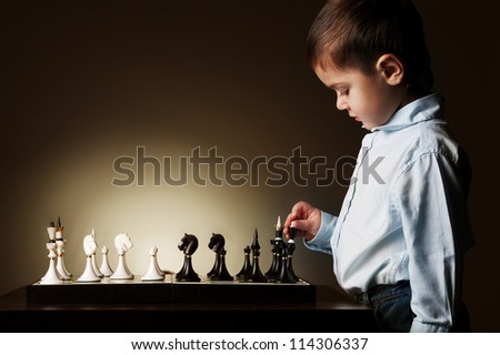 little boy plays chess