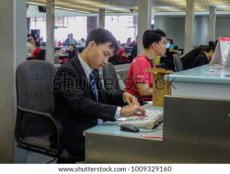 Saigon, Vietnam - Mar 28, 2017. Staffs working at Check-in Counter of Tan Son Nhat Airport in Saigon, Vietnam. Tan Son Nhat is the busiest international airport in Vietnam.