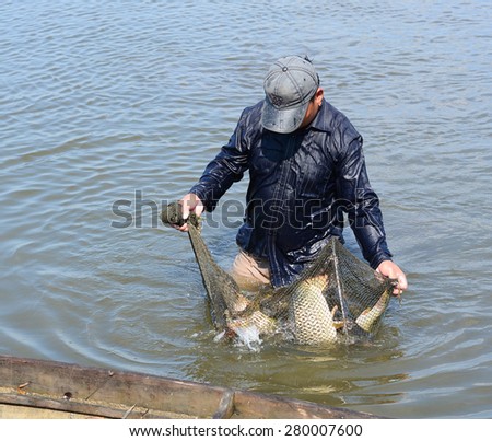 MEKONG DELTA, VIETNAM - MARCH 12, 2015: Unidentified fisherman fishing on small river in Dong Thap, southern Vietnam.
