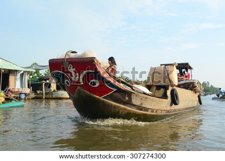 TIEN GIANG PROVINCE, VIETNAM - FEB 11, 2015: A boat carry goods at Cai Be Floating Market. Cai Be Market is one of most famous floating market in Vietnam.
