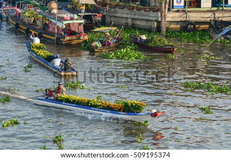 Soc Trang, Vietnam - Feb 2, 2016. People carrying flowers on river in Nga Nam, southern Vietnam. Nga Nam is one of famous market in southern Vietnam.