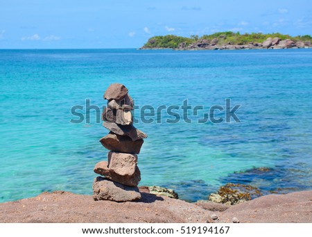 Idyllic tropical beach with the rocks in sunny day