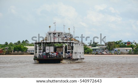 An Giang, Vietnam - Aug 7, 2016. People on the ferry across Mekong River in Southern Vietnam. The Mekong is the world's 12th-longest river and the 7th-longest in Asia.