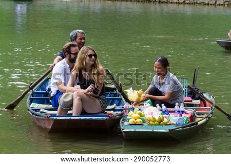 NINHBINH, VIETNAM - May 17, 2015: Unidentified Vietnamese persons on the Floating Market at "Ngo Dong" river in Tam Coc Bich Dong heritage, NinhBinh province, Vietnam.