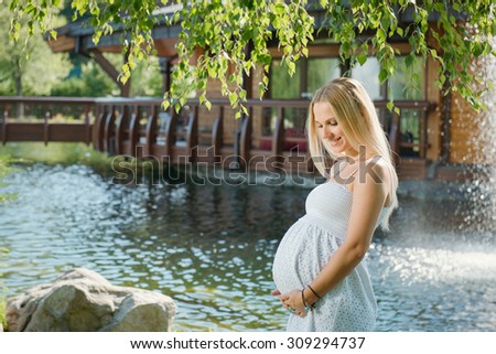 https://thumb1.shutterstock.com/display_pic_with_logo/3224303/309294737/stock-photo-beautiful-pregnant-woman-on-the-walk-outdoor-near-the-house-with-lake-309294737.jpg