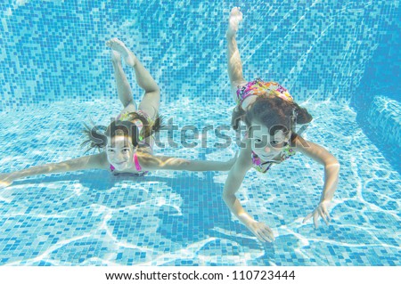happy smiling underwater children in swimming pool beautiful healthy girls swim and having fun in - Kids Swimming Underwater happy smiling underwater children in swimming pool beautiful healthy girls swim and having fun in - Kids Swimming Underwater