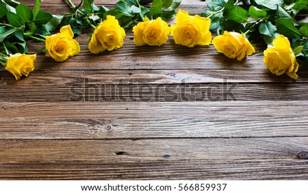 The bouquet of beautiful fresh yellow roses lies on a wooden table.
Card template by St. Valentine's Day or the international Women's Day.