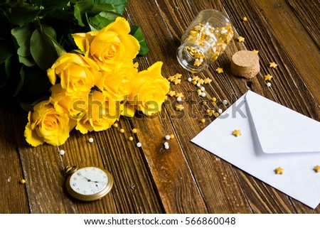 The bouquet of beautiful fresh yellow roses lies on a wooden table.
Card template by St. Valentine's Day or the international Women's Day.