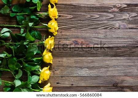 The bouquet of beautiful fresh yellow roses lies on a wooden table.
Card template by St. Valentine's Day or the international Women's Day.