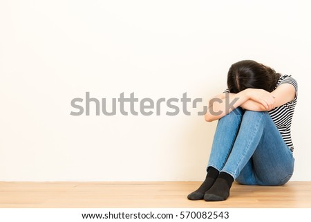 Sad Woman Sitting On The Floor Embracing Her Knee Stock 