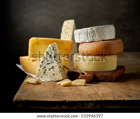various types of cheese on rustic wooden table