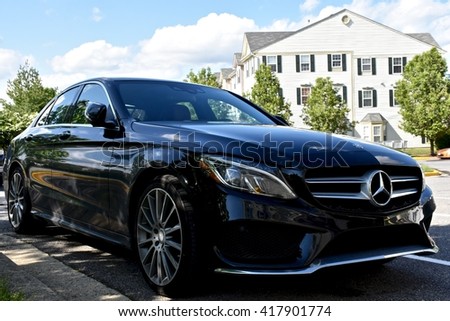 MARYLAND, USA - MAY 7, 2016: A black Mercedes Benz C400. Mercedes Benz is a luxury car dealer and manufacturer.