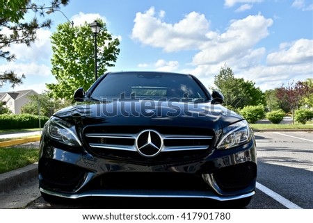 MARYLAND, USA - MAY 7, 2016: A black Mercedes Benz C400. Mercedes Benz is a luxury car dealer and manufacturer.