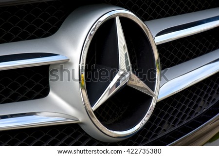 MARYLAND, USA - MAY 18, 2016: A Mercedes-Benz logo on a black C400. Mercedes-Benz is a luxury car dealer and manufacturer.
