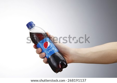 Kuala Lumpur,Malaysia 9th April 2015,Holding a can of Pepsi . Pepsi is a carbonated soft drink produced and manufactured by PepsiCo Inc. an American multinational food and beverage company.