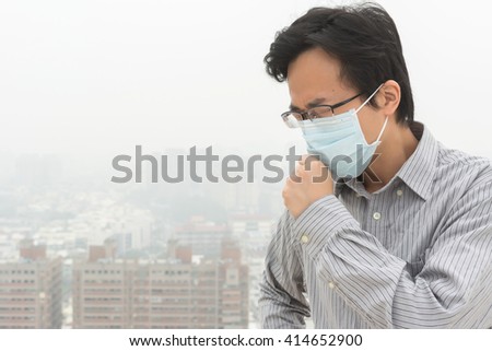 concept of air pollution with a Asian young man with a mask