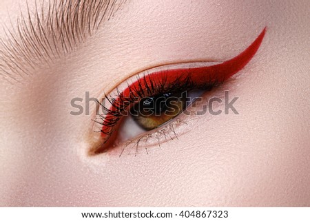 Elegance close-up of beautiful female eye with fashion trend bright colors eyeshadow and eyeliner. Macro shot of beautiful woman's face part with makeup. Cosmetics, beauty and make-up