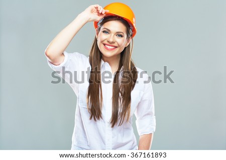 Isolated studio portrait of smiling woman manager of real estate. Business woman wearing protect helmet.