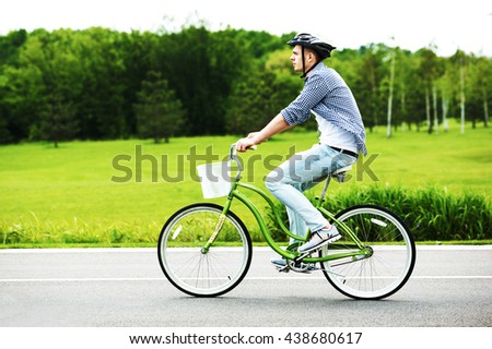 a young man riding a bicycle in a park