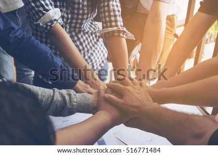 Business people join hand together during their meeting