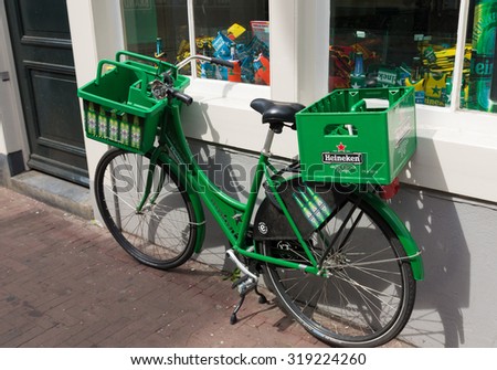AMSTERDAM - AUGUST 2, 2015: Heineken bicycle in front of the heineken brand store. The Heineken Brand Store is the official store of Heineken with more than 250 unique Heineken products and a Beershop