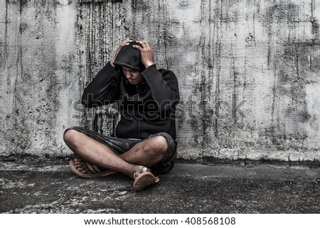 Drug abuse concept., overdose asian male drug addict with problems, man in hood with hands on his head