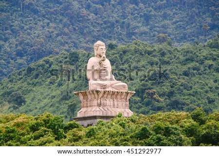 HUE, VIETNAM - CIRCA AUGUST 2013: Buddha statue of Truc Lam Bach Ma Buddhist Temple in the middle of Truoi Lake in Hue (Vietnam)