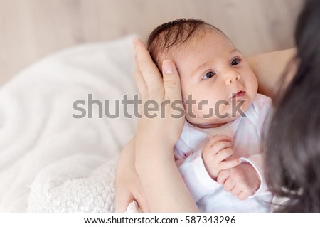 Mother with her newborn baby mother is holding her little baby girl photo with Mother with her newborn baby mother is holding her little baby girl photo with